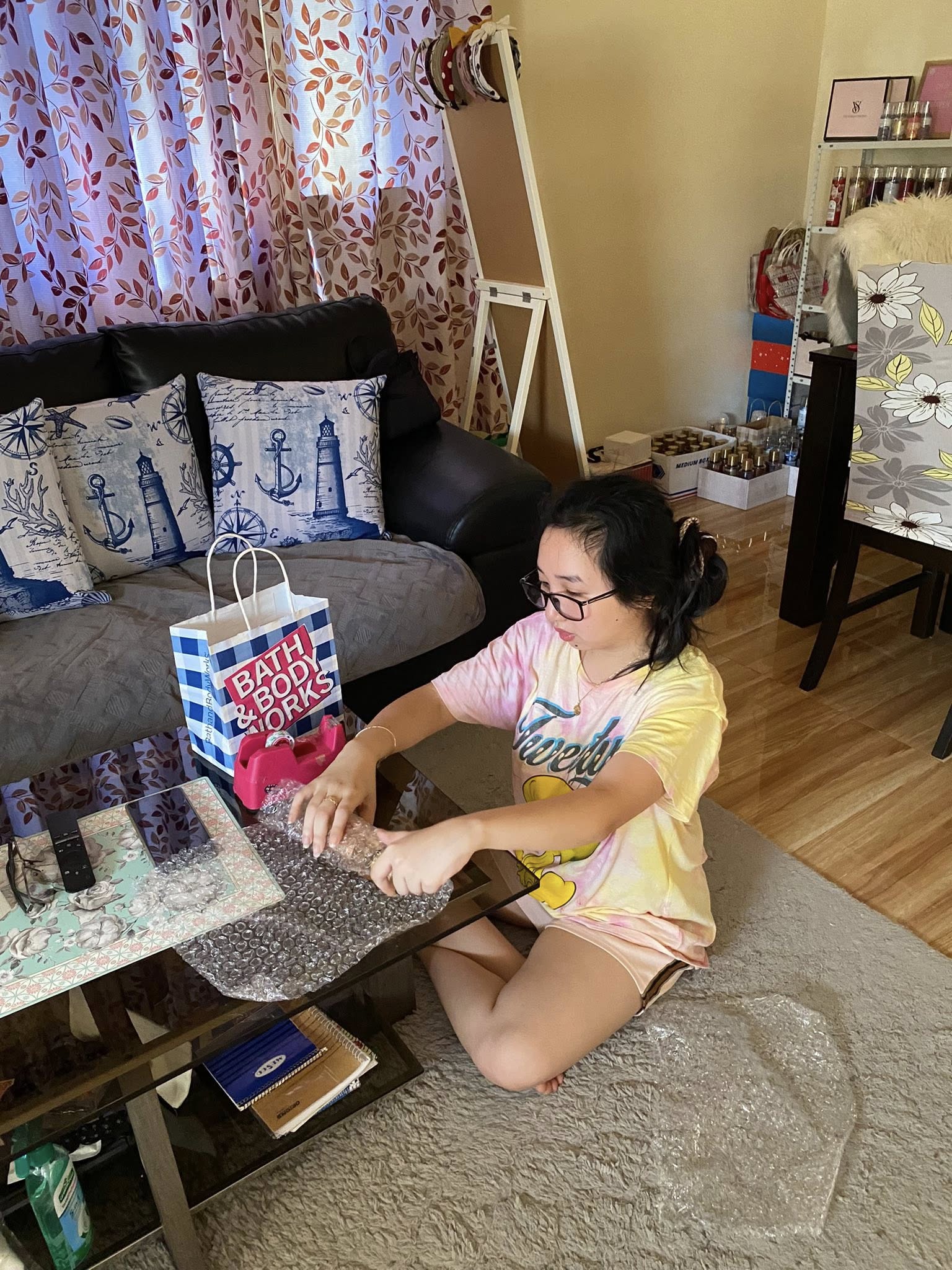 Chin-chin, founder of Chin Chin's Haven, carefully packaging an order at home